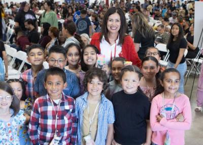 Superintendent Copher with students at the Young Authors' Faire event